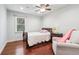 Cozy bedroom featuring light blue walls, hardwood flooring, and bright natural light at 2411 Mitchell Ne Rd, Marietta, GA 30062