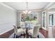 Bright dining room with glass table, a stylish chandelier, and scenic backyard views at 2411 Mitchell Ne Rd, Marietta, GA 30062