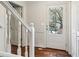 Bright foyer featuring hardwood floors, a glass paneled front door, and white staircase banister at 2411 Mitchell Ne Rd, Marietta, GA 30062