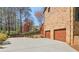 Two-car garage with a brick facade and concrete driveway offers ample parking space and curb appeal at 2411 Mitchell Ne Rd, Marietta, GA 30062