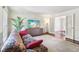 Comfortable living room with a floral sofa, a TV, hardwood floors and double doors to the dining room at 2411 Mitchell Ne Rd, Marietta, GA 30062