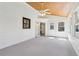 Inviting sunroom with a ceiling fan, wood plank ceiling, and access to the outdoors through a white door at 2411 Mitchell Ne Rd, Marietta, GA 30062