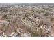 An aerial view captures a quaint neighborhood nestled amongst towering trees at 2611 Winterthur Main Nw, Kennesaw, GA 30144