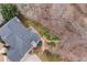 Aerial view showing the backyard with a deck and mature trees at 2611 Winterthur Main Nw, Kennesaw, GA 30144