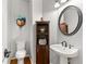 Charming powder room featuring pedestal sink, toilet, decor, and stylish paint at 2611 Winterthur Main Nw, Kennesaw, GA 30144