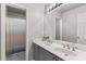 Bright bathroom features a double vanity, ample lighting and shower with decorative tile at 2611 Winterthur Main Nw, Kennesaw, GA 30144