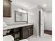 Bathroom featuring granite countertop, dark cabinets and a view of the toilet at 2611 Winterthur Main Nw, Kennesaw, GA 30144