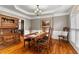 Formal dining room featuring tray ceiling, wainscoting, and elegant wooden furniture at 2611 Winterthur Main Nw, Kennesaw, GA 30144