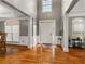 Open foyer with hardwood floors, tall ceilings, and natural light from large windows at 2611 Winterthur Main Nw, Kennesaw, GA 30144