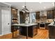 Contemporary kitchen features dark wood cabinets, a center island, and stainless steel appliances at 2611 Winterthur Main Nw, Kennesaw, GA 30144