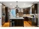 Charming kitchen with dark cabinetry, center island, stainless steel appliances, and stylish backsplash at 2611 Winterthur Main Nw, Kennesaw, GA 30144