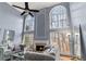 Spacious living room with tall windows, fireplace, hardwood floors, and comfortable seating at 2611 Winterthur Main Nw, Kennesaw, GA 30144