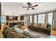 Open concept living area featuring kitchen, fireplace, comfortable seating, and natural light at 2611 Winterthur Main Nw, Kennesaw, GA 30144