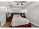 A spacious main bedroom features hardwood floors, modern lighting, and stylish design at 2611 Winterthur Main Nw, Kennesaw, GA 30144