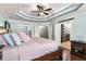 Main bedroom featuring a tray ceiling, hardwood floors, and entry to a bathroom at 2611 Winterthur Main Nw, Kennesaw, GA 30144