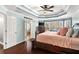 Main bedroom boasts a tray ceiling, hardwood floors, sitting area and a doorway to a bathroom at 2611 Winterthur Main Nw, Kennesaw, GA 30144