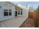 A tiled back patio with a sliding glass door leading inside and a wooden fence for privacy at 4531 Flowering Br, Powder Springs, GA 30127