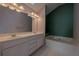 Elegant bathroom featuring a soaking tub, double vanity, and bright lighting at 4531 Flowering Br, Powder Springs, GA 30127