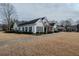 Traditional-style building featuring black shutters, a well-manicured lawn, and a paved sidewalk at 4531 Flowering Br, Powder Springs, GA 30127
