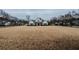 A large white home with black shutters sitting at the end of a large, dry field at 4531 Flowering Br, Powder Springs, GA 30127