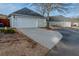 A large driveway leading up to the garage on a light-green home with a gray roof at 4531 Flowering Br, Powder Springs, GA 30127
