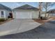 Detached garage with a concrete driveway and light siding, with ample parking space at 4531 Flowering Br, Powder Springs, GA 30127