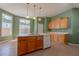 Bright kitchen featuring an island, double sink, tile floor, and lots of natural light at 4531 Flowering Br, Powder Springs, GA 30127
