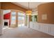 Open living room featuring neutral paint, carpet, wainscoting, a fireplace, and windows at 4531 Flowering Br, Powder Springs, GA 30127