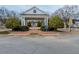 A neighborhood entrance with a white pergola, red brick walkway, and manicured shrubs at 4531 Flowering Br, Powder Springs, GA 30127