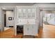 Chic bar area with wine cooler, glass-front cabinets, and marble countertops at 4921 Slaton Dr, Acworth, GA 30101