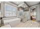 Elegant bathroom with soaking tub and frameless glass shower, and tile floors at 4921 Slaton Dr, Acworth, GA 30101