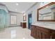 Bright, airy bathroom with double sink vanity, marble floors, and a glass shower at 4921 Slaton Dr, Acworth, GA 30101