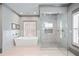 Contemporary bathroom features a freestanding tub and glass shower with gray accents and white tile at 4921 Slaton Dr, Acworth, GA 30101
