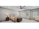 Cozy bedroom featuring neutral walls and carpet, a ceiling fan, and windows with light-filtering shutters at 4921 Slaton Dr, Acworth, GA 30101