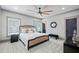 Comfortable bedroom boasts neutral decor, natural light, plush carpet, and a modern ceiling fan at 4921 Slaton Dr, Acworth, GA 30101
