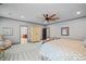 Spacious bedroom with sitting area, light grey walls, ceiling fan, and plush carpeting at 4921 Slaton Dr, Acworth, GA 30101