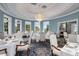 An elegant dining room featuring a chandelier, large windows, and tastefully decorated tables at 4921 Slaton Dr, Acworth, GA 30101