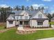 Charming two-story home featuring manicured landscaping, a walkway, and a welcoming front porch for relaxing outdoors at 4921 Slaton Dr, Acworth, GA 30101
