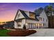 Expansive three-car garage featuring modern glass doors, providing ample parking and enhancing the home's contemporary design at 4921 Slaton Dr, Acworth, GA 30101