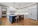 Modern kitchen features large island, white cabinetry and stainless steel appliances at 4921 Slaton Dr, Acworth, GA 30101