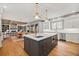 Spacious open kitchen with a large island, modern lighting, and stainless appliances at 4921 Slaton Dr, Acworth, GA 30101