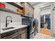 Convenient laundry room with large washer and dryer and custom cabinets at 4921 Slaton Dr, Acworth, GA 30101