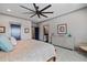 Comfortable main bedroom features a large ceiling fan, ensuite access, natural light, and neutral tones at 4921 Slaton Dr, Acworth, GA 30101
