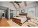 Comfortable main bedroom with vaulted ceilings, exposed beams, and hardwood floors at 4921 Slaton Dr, Acworth, GA 30101