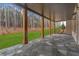 Covered stone patio featuring wooden support beams, offering a tranquil outdoor retreat with views of the landscaped yard at 4921 Slaton Dr, Acworth, GA 30101