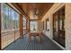 Relaxing screened porch with wood-burning fireplace, ceiling fan, and ample seating area at 4921 Slaton Dr, Acworth, GA 30101