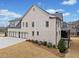 Spacious rear exterior featuring an expansive three-car garage and manicured lawn, perfect for Gathering and entertaining at 4921 Slaton Dr, Acworth, GA 30101