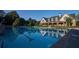 Relaxing view of the community pool showcasing clear blue water and the stately clubhouse beyond at 4921 Slaton Dr, Acworth, GA 30101