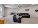 Finished basement featuring a large seating area, neutral carpet, an entertainment area, and a ceiling fan at 197 Saddleridge Dr, Bremen, GA 30110