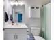 This bathroom features a white vanity, medicine cabinet, modern lighting, and bath/shower combo at 197 Saddleridge Dr, Bremen, GA 30110